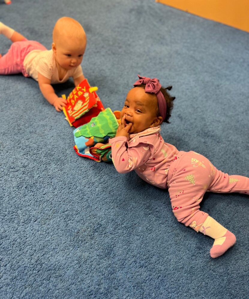 Infants playing with a toy.