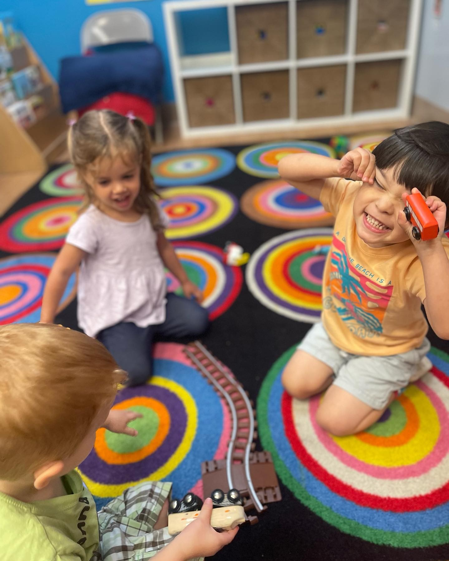 Little kids playing and making faces at the camera.
