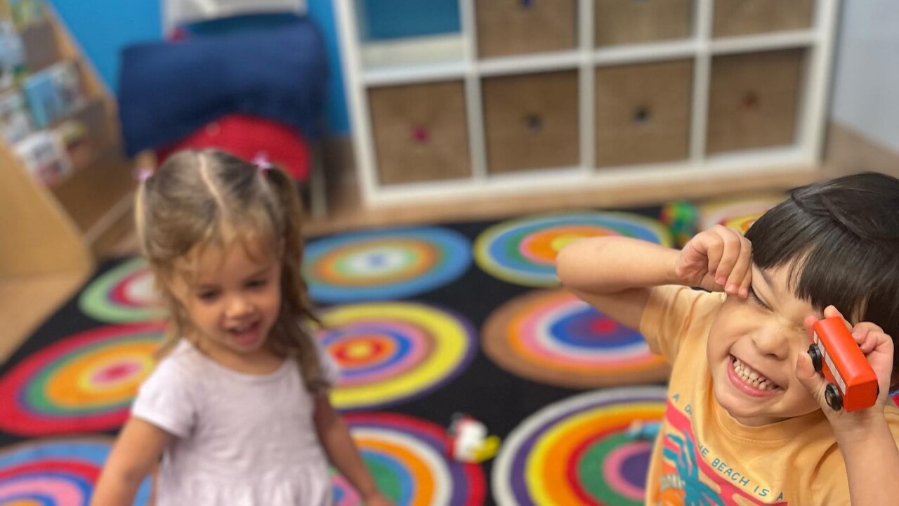 Little kids playing and making faces at the camera.