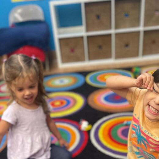 Little kids playing and making faces at the camera.
