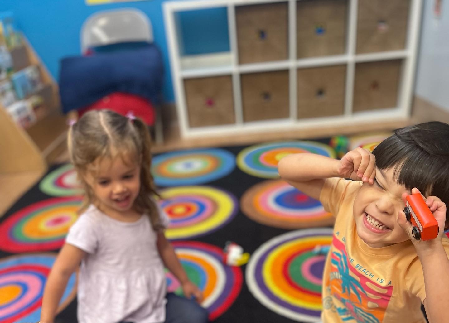 Little kids playing and making faces at the camera.